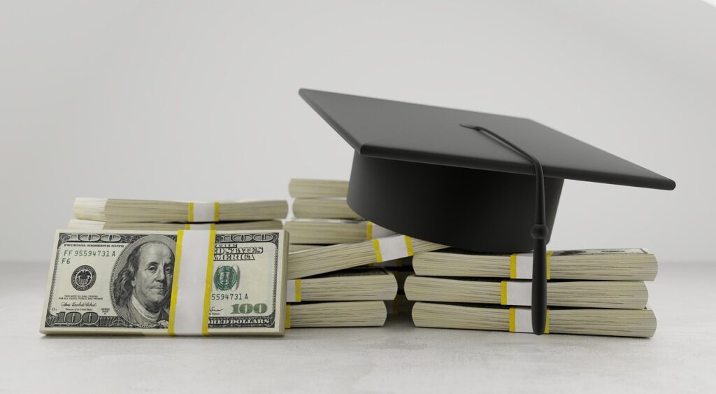 A graduation cap sits on stacks of dollars.