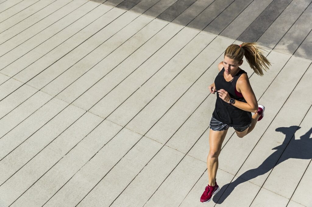 A women runs outside as she knows how to stay fit on a budget. 