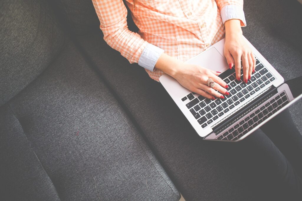 A woman uses her laptop to search "How to pay off 40k in student loans".