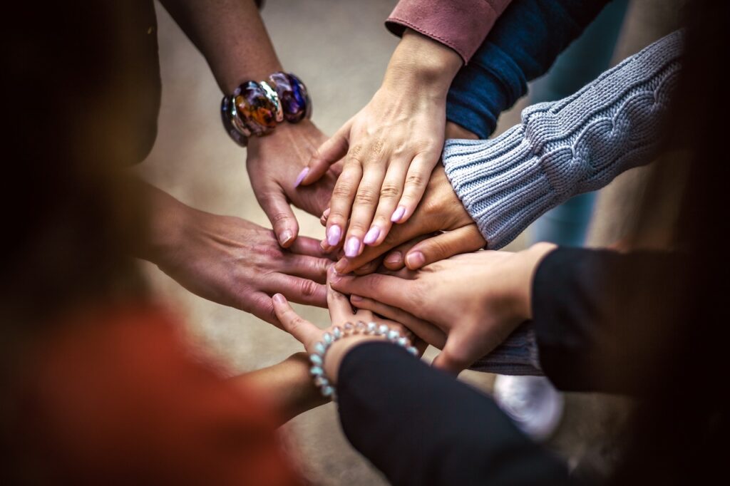 A group of women bring their hands in for a break. 